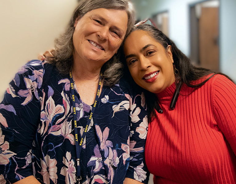 Two American Management Services employees pose for photo